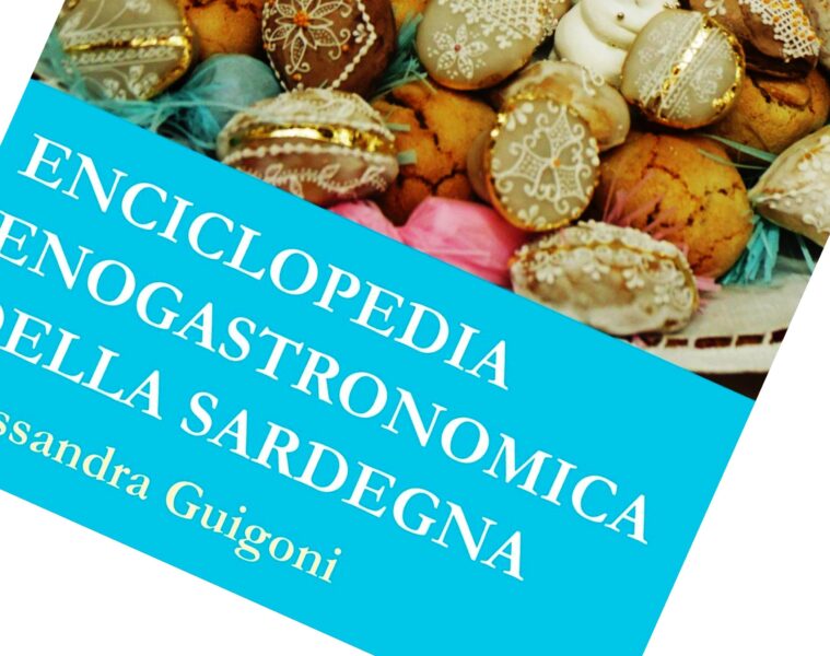Book cover: Enciclopedia Enogastronomica della Sardegna on a bright blue banner over a background of decorated pastries/cookies, rotated diagonal view.