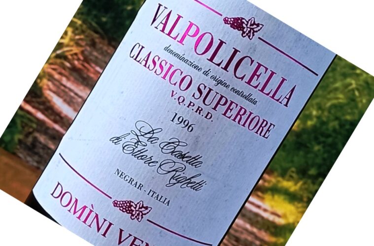 Close-up of a wine bottle label reading 'Valpolicella Classico Superiore' with the year 1996 visible, set outdoors.