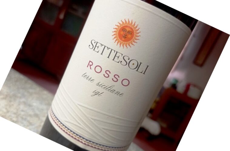 Wine bottle labeled Sette Soli Rosso with a sun emblem, Terre Siciliane IGT, tilted on a countertop