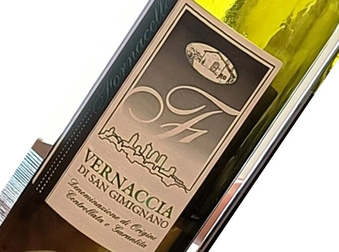 Wine bottle label reading 'VERNACCIA DI SAN GIMIGNANO' with skyline graphic and vintage seal, angled in a close-up view