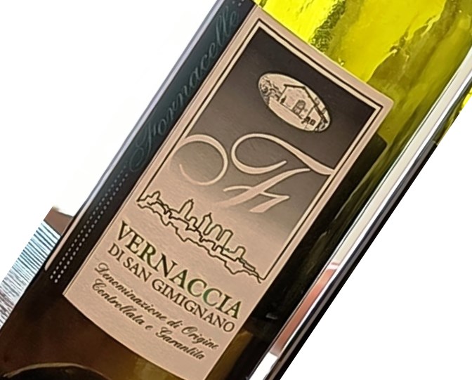 Wine bottle label reading 'VERNACCIA DI SAN GIMIGNANO' with skyline graphic and vintage seal, angled in a close-up view