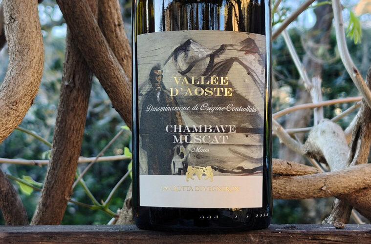 Wine bottle with label 'Vallée d'Aoste Chambave Muscat', featuring a mountain scene and gold accents among tree branches