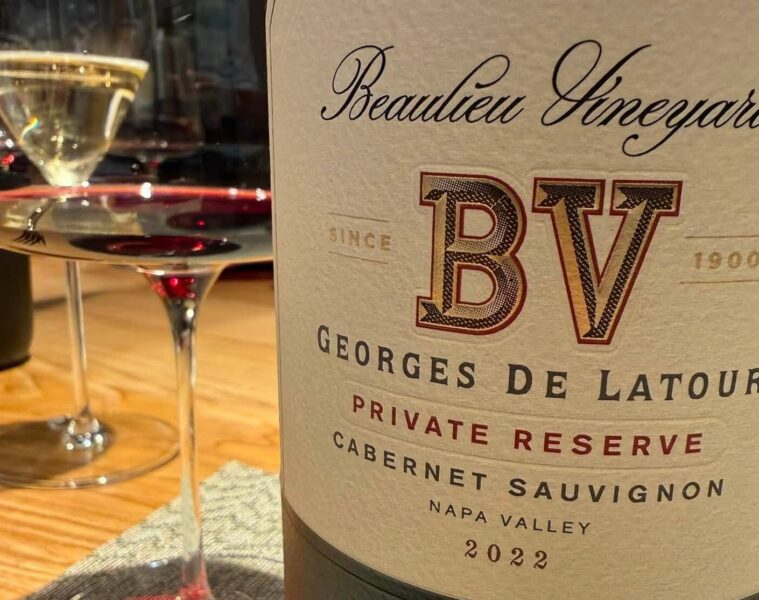 Close-up of a wine bottle label reading Beaulieu Vineyards BV Georges De Latour Private Reserve Cabernet Sauvignon Napa Valley 2022 with a wine glass beside it