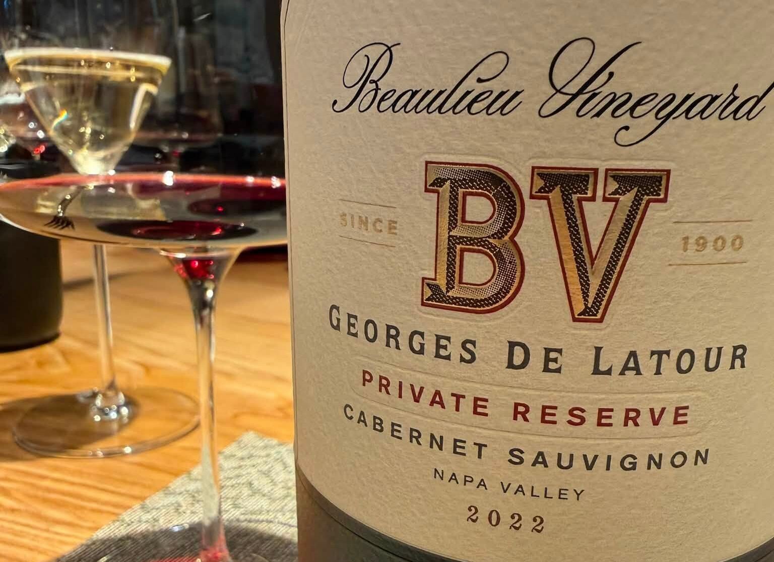 Close-up of a wine bottle label reading Beaulieu Vineyards BV Georges De Latour Private Reserve Cabernet Sauvignon Napa Valley 2022 with a wine glass beside it