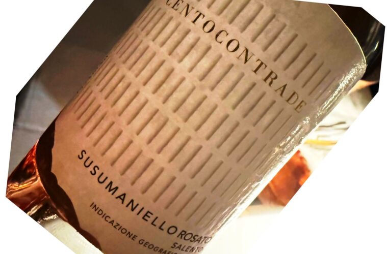 Close-up of a wine bottle label with Italian text and a textured beige background, suggesting origin and designation of the wine.